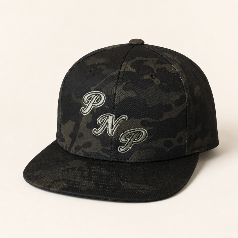 PNP Snapback in black multicam — front three-quarter view with muted sage PNP embroidery